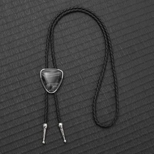 Detail view of a vintage PU braided bolo tie with a marble-patterned slider.