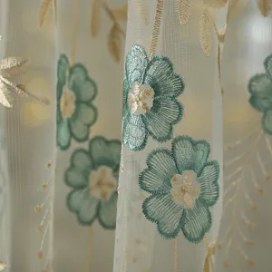 French floral sheer curtain detail, elegant green and gold embroidery on breathable mesh.