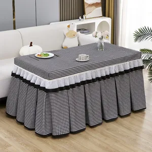 Cozy checkered table cover detail featuring elegant lace ruffles and soft flannel fabric.