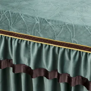 Detaillierte Nahaufnahme der grünen Samt-Tischdecke mit geprägtem Blattmuster und Rüschen.