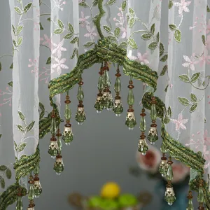 Closeup of Korean style lace curtain with green floral embroidery and crystal bead drops.