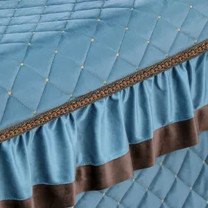 Detailed view of winter quilted heating table cover with elegant lace trim and ruffles.