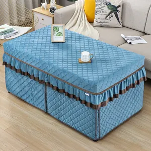 Quilted winter heating table cover in blue with brown ruffles, elegant rectangular textile home decor.