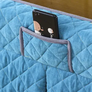 Detailed close-up of blue quilted heating table cover fabric texture and functional storage pocket design.