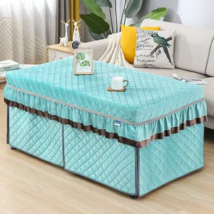 Thickened quilted heater table cover detail, teal velvet fabric with elegant brown ruffled skirt.