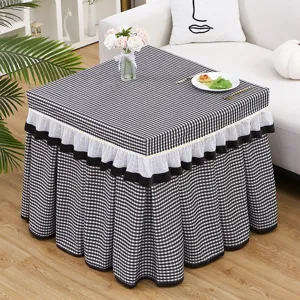 Black and white checkered table cover with pleated ruffle skirt, perfect for heating tables.