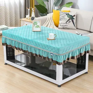 Quilted teal winter heating table cover detail, plush velvet fringe skirt, cozy home decor.