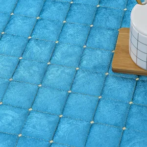 Close-up detail of thickened blue quilted heating table cloth with delicate diamond grid patterns.