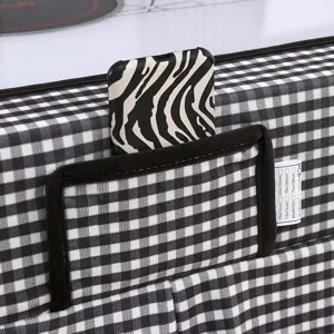 Black and white checkered table cover detail featuring a storage pocket and size tag.