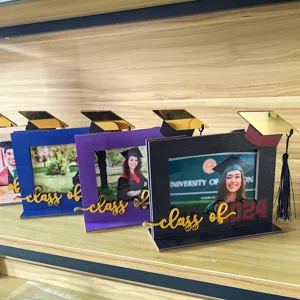 Detailed macro view of multiple colorful 2024 graduation wooden photo frames with decorative tassels