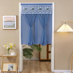 Detailed view of blue short door curtain with floral embroidery mesh and tie back design.