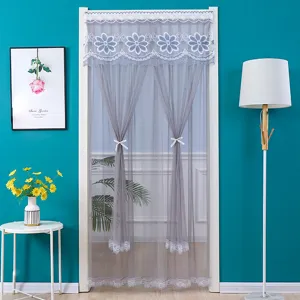 Grey lace mesh door curtain detail showcasing delicate floral embroidery and elegant ribbons.
