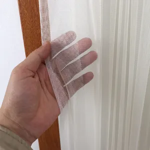 Detailed view of the sheer white lace curtain fabric showing soft texture and transparency.