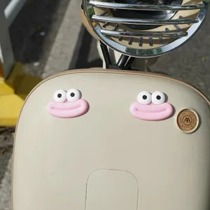 Cute electric vehicle decoration accessory big mouth monster sticker detail showcase.