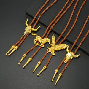 Detailed view of golden bull skull, eagle, and horse pendants for Western bolo ties.