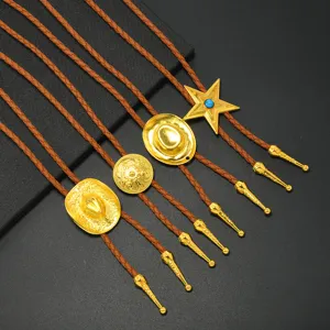 Detail view of various vintage western cowboy bolo ties with intricate golden pendants