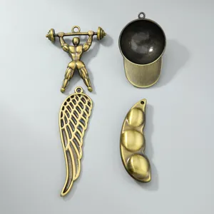 Detailed macro shot of vintage bronze jewelry charms in various creative shapes.