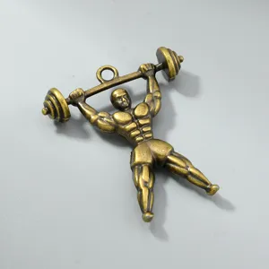 Macro view of a vintage bronze bodybuilder pendant for DIY jewelry making accessories