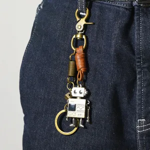 Vintage robot keychain with leather strap styled as a hip-hop pant accessory on jeans
