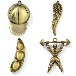 Set of 4 vintage bronze charms including cap, wing, pea and barbell man for DIY jewelry