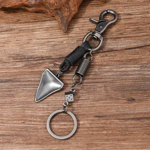 Detailed macro view of a vintage metal hip-hop keychain with dice and spring charm