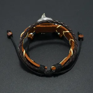 Detail view of Bohemian leather watch bracelet with woven straps and feather pendant
