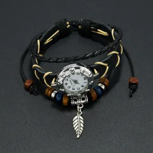 Close-up detail of a vintage bohemian leather bracelet watch featuring a silver feather charm