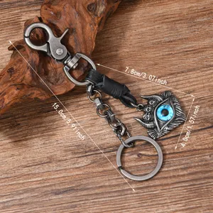 Retro punk metal keychain featuring a blue evil eye pendant with skull details on wood