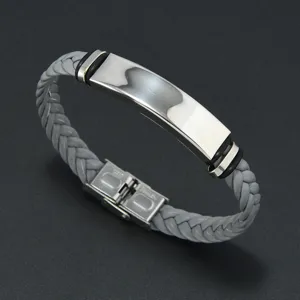 Detailed view of grey braided bracelet with polished silver stainless steel plate