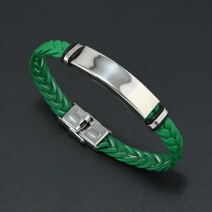 Detail view of green braided leather bracelet with polished stainless steel ID plate
