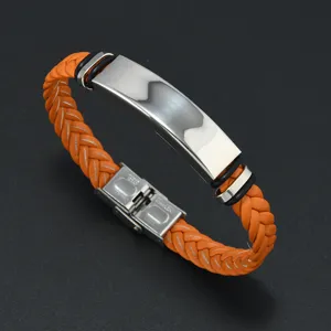 Detailed view of an orange braided leather bracelet with a polished stainless steel plate