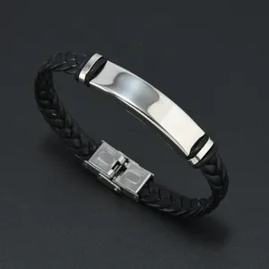 Detailed view of men's braided leather bracelet with polished stainless steel plate.