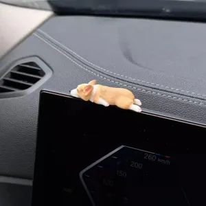 Detail shot of cute sleeping Corgi dog car dashboard ornament figurine interior decor.