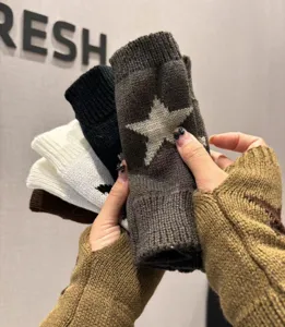 Knitted fingerless gloves with star pattern, perfect for autumn and winter warmth.