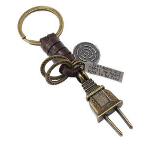 Vintage alloy plug keychain featuring brown leather wrap and engraved metal charms