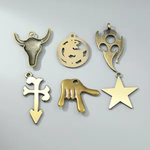 Macro view of vintage bronze pendants in bull head, dragon, and flame shapes for DIY jewelry