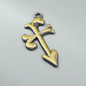 Close-up detail of a vintage dragon flame pendant featuring a rustic two-tone finish