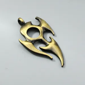 Macro view of a vintage bronze flame pendant with detailed tribal dragon engravings