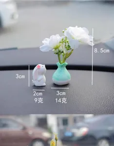 Miniature car dashboard ornament set with cute rabbit figurine and small ceramic vase flowers.