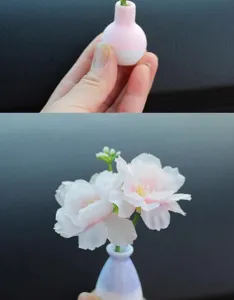 Mini car vase ornament detail showing miniature size in hand and floral decoration setup.