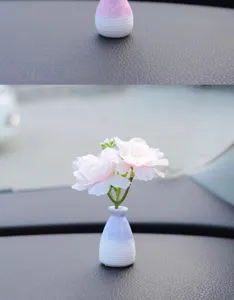 Mini car vase ornament detail showing beautiful floral decor on the dashboard console.