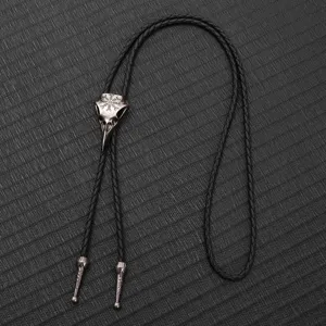 Vintage bird skull bolo tie with engraved Nordic runes on black braided leather cord