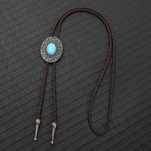 Vintage turquoise bolo tie with braided brown cord and ornate silver metal tips.
