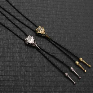Macro view of vintage bird skull bolo ties featuring intricate Nordic engravings