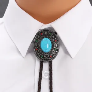 Close-up of vintage turquoise bolo tie with western style alloy pendant on white shirt
