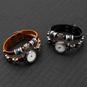 Detail of retro punk style cowhide leather bracelet watches with metal cross and studs