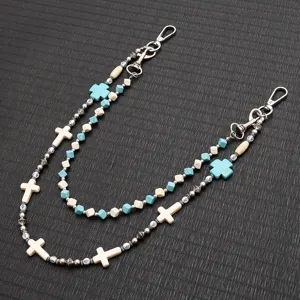 Detailed view of a double-layer beaded waist chain with turquoise and cream cross charms
