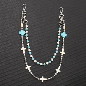 Close-up detail of double-layered beaded trouser chain with white and blue cross charms