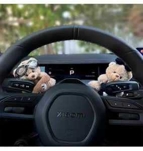 Detailed view of cute plush bear ornaments installed on car steering column and wiper levers.