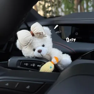 Cute car steering wiper bear plush doll ornament, fluffy white interior decor accessory for women.
